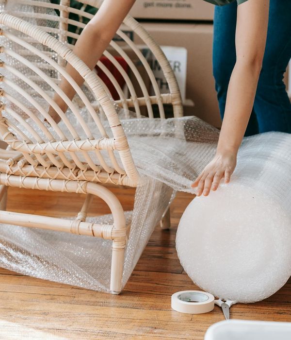 Person moving gracefully in a bright, minimalist room.