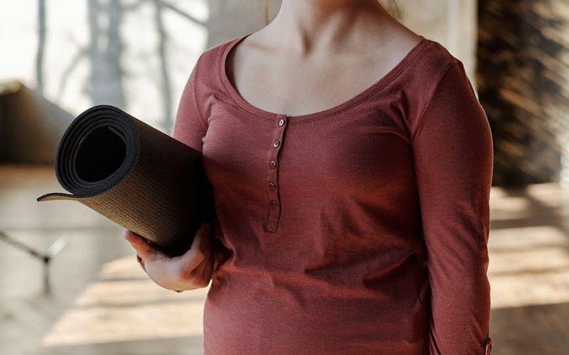 Spacious, well-lit room with wooden floors, ready for exercise.